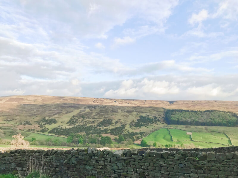 The rolling hills of the Yorkshire Dale against a dry stone wall