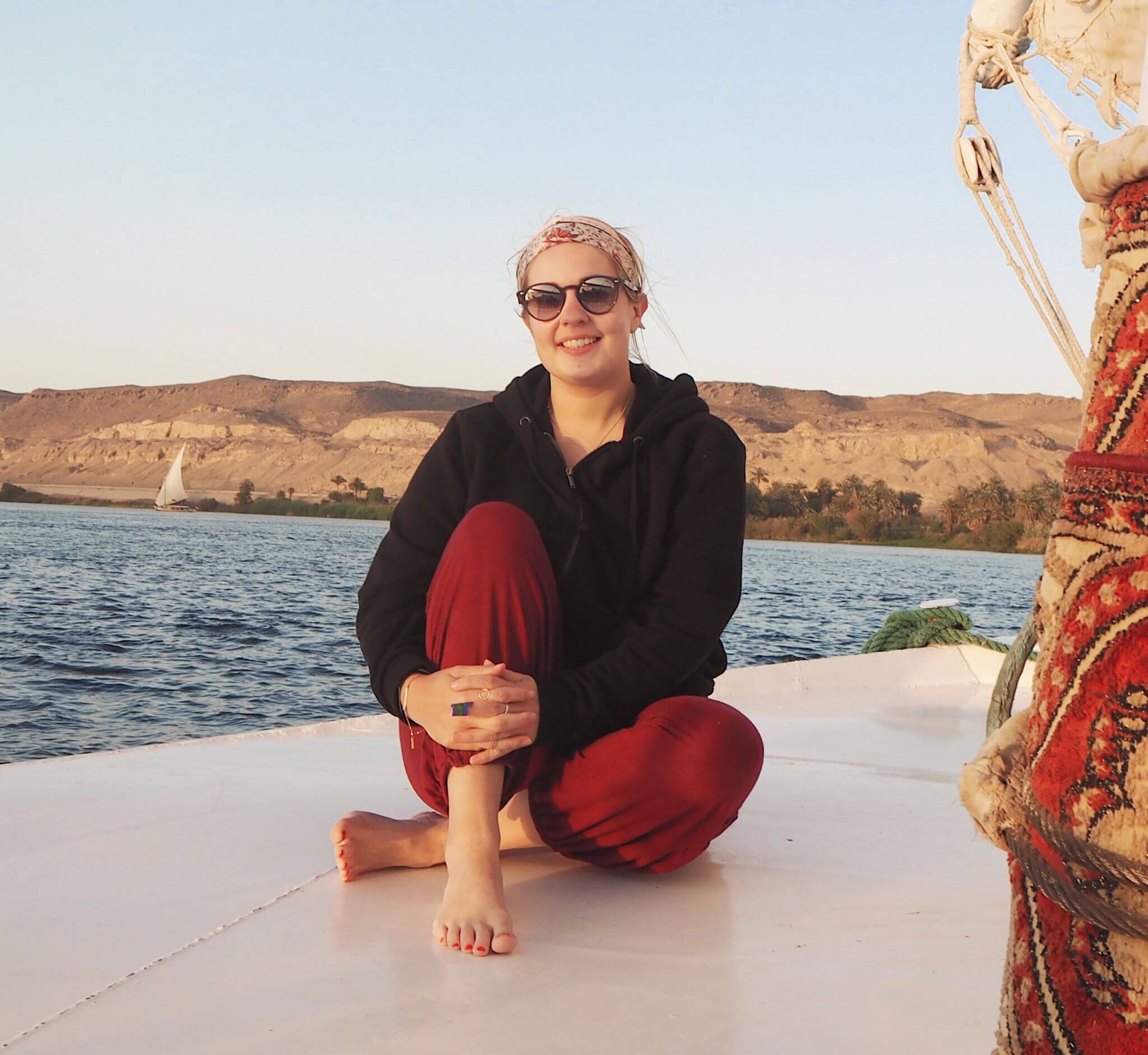 sitting on the prow of the boat sailing along the Nile