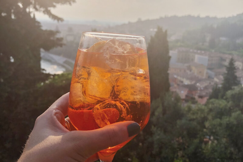 image of Aperol Spritz at sunset from Castel San Pietro