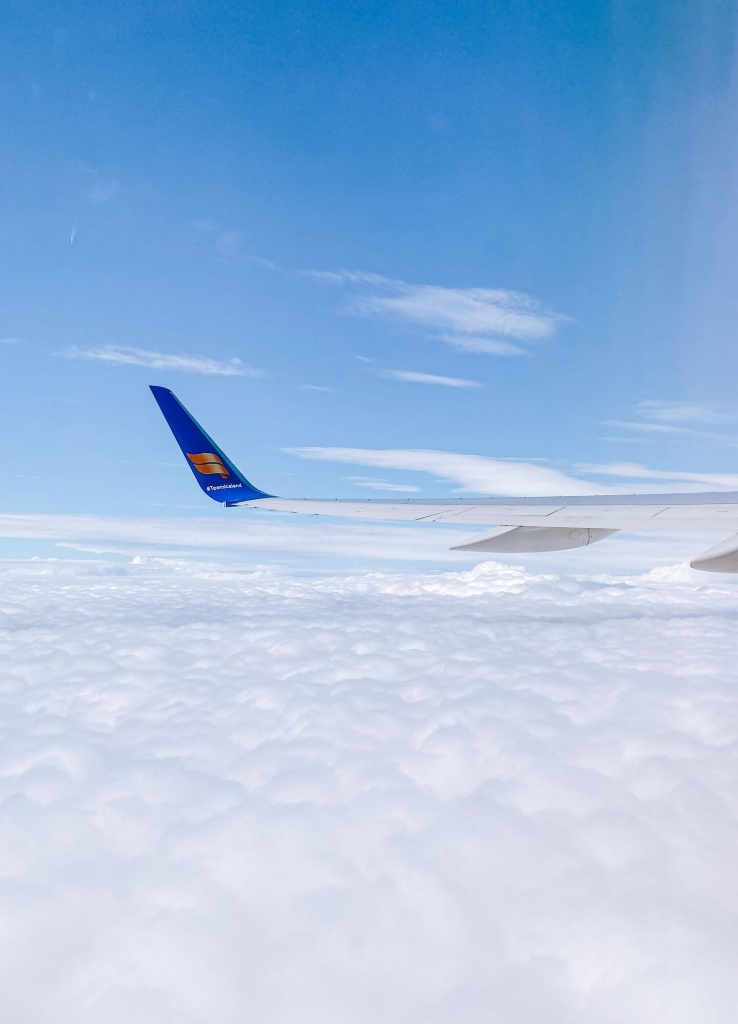 image of icelandair plane over clouds