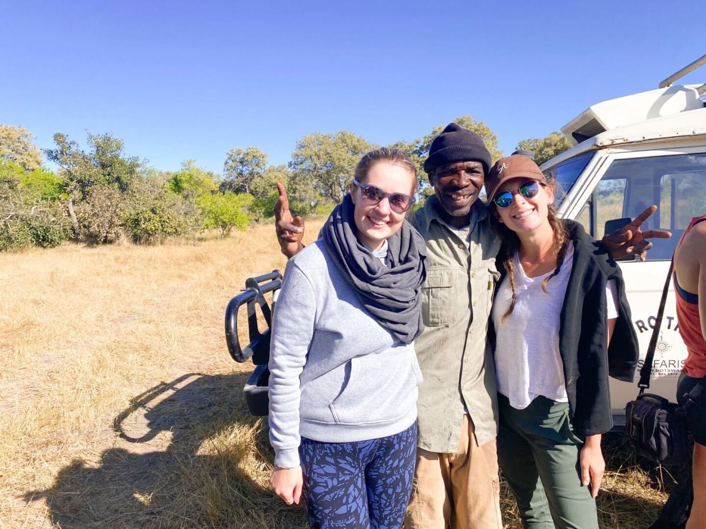 image of two women standing with a poler after camping in the Okavango Delta