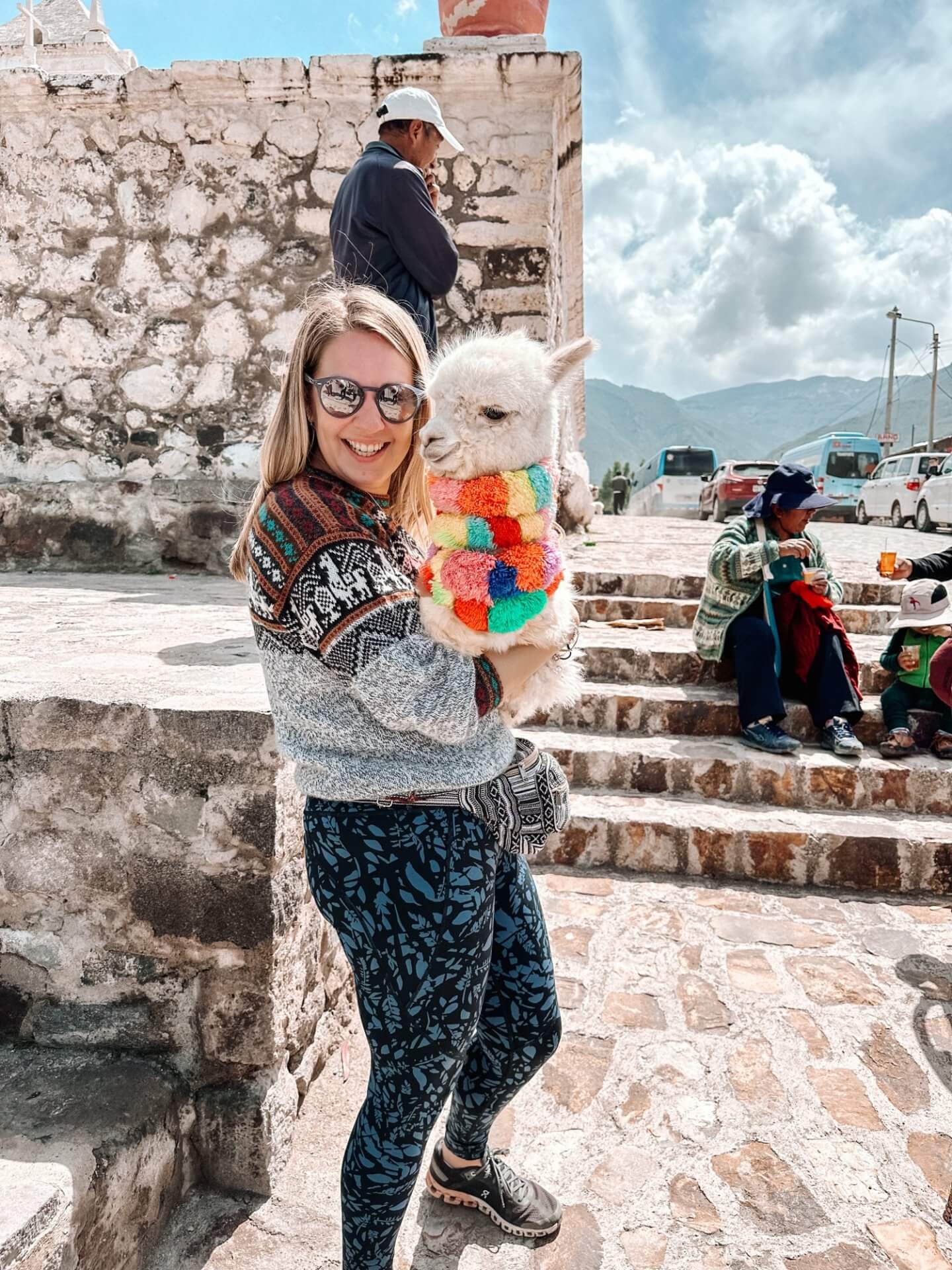 image of a woman holding a baby alpaca in the Colca Canyon in Peru
