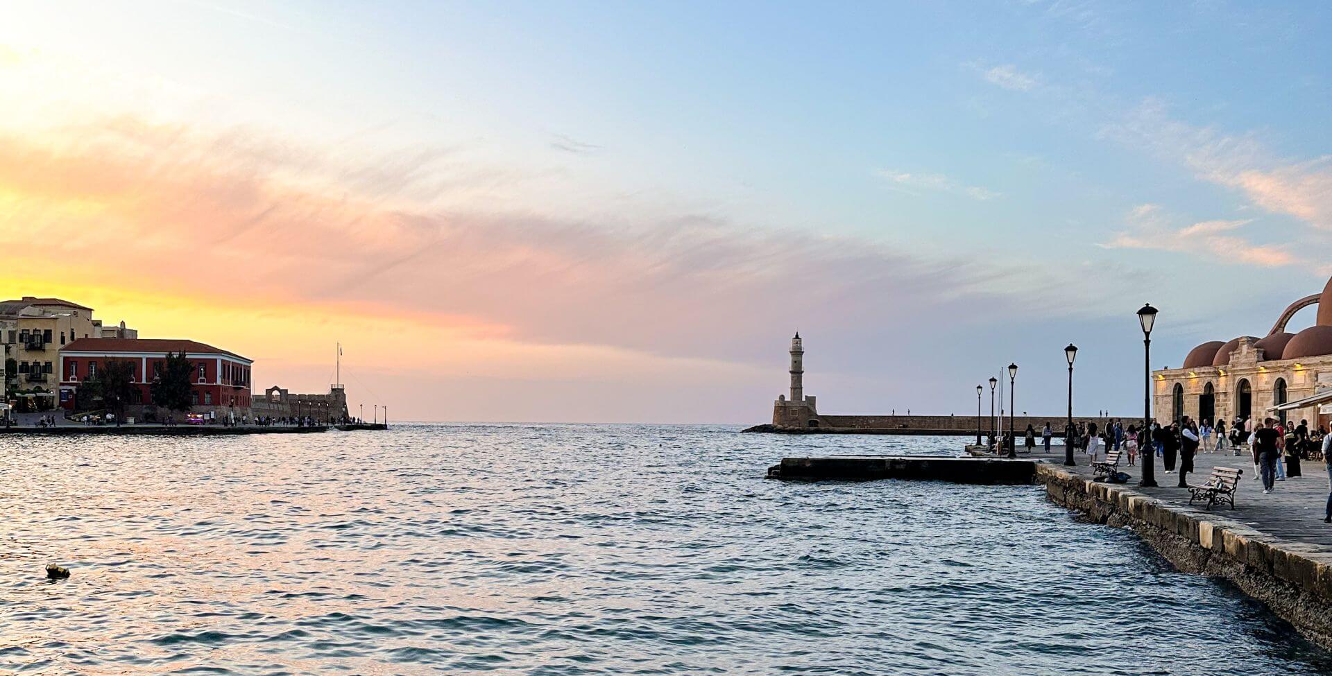 image of sunset over the Egyptian Lighthouse and Venetian Harbour, one of the top things to do in Chania