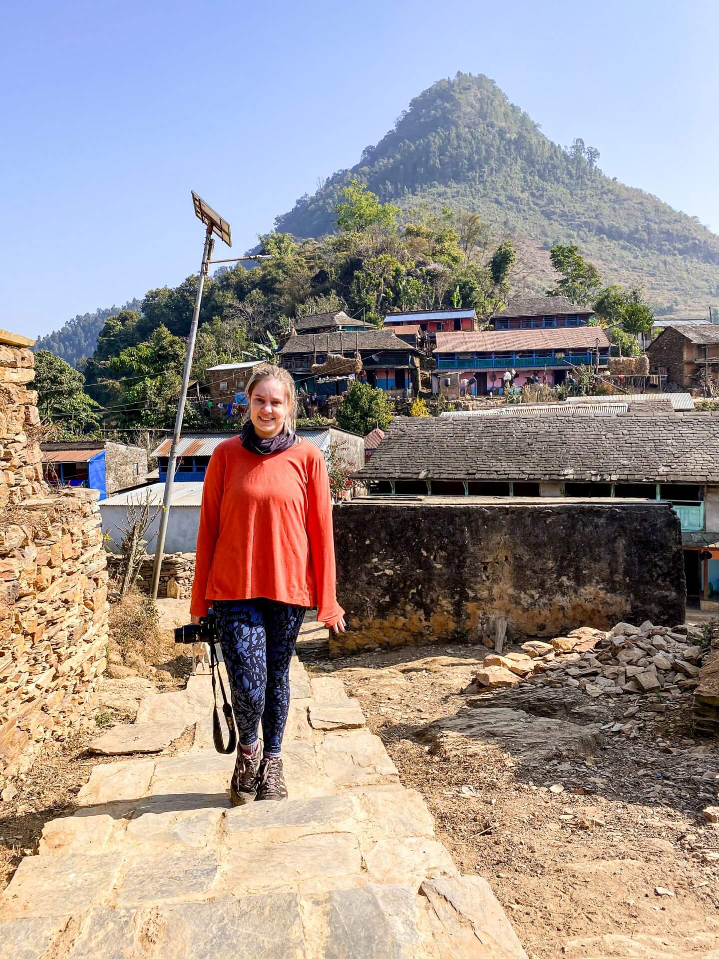 image of a woman standing on a path in the village of ramkot