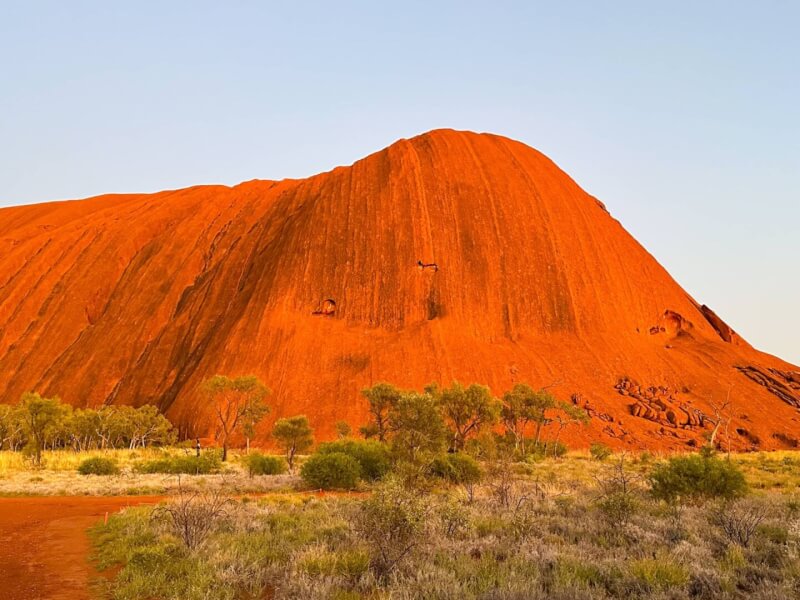 image of Uluru glowing orange at sunrise