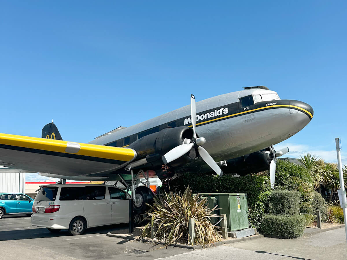 The iconic McDonald's restaurant in Taupo, New Zealand, uniquely housed inside a retired Douglas DC-3 plane, a must-see roadside attraction.