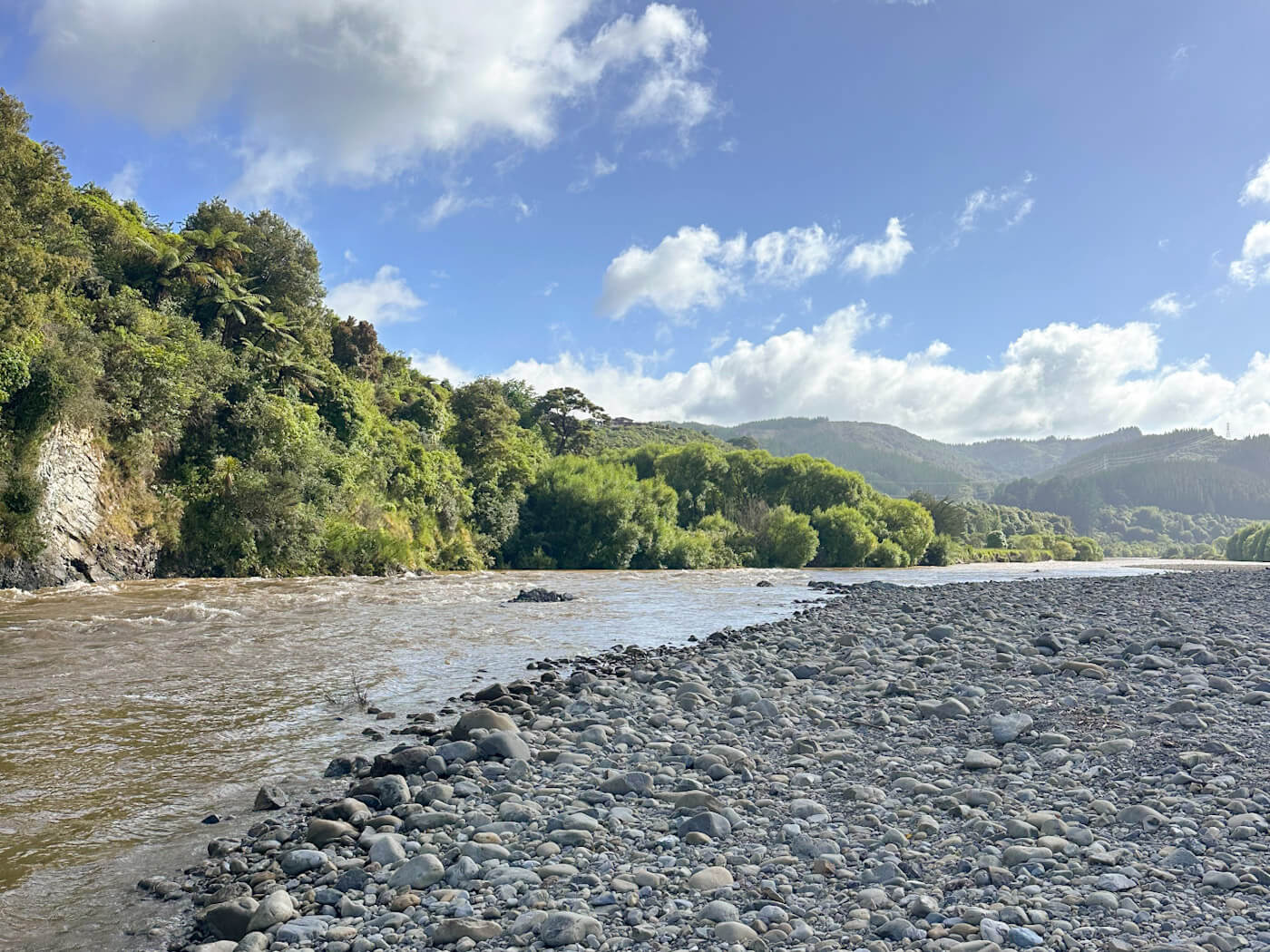 A scenic view of the Hutt River in Upper Hutt, New Zealand, which served as the filming location for the Great River Anduin in The Lord of the Rings: The Fellowship of the Ring