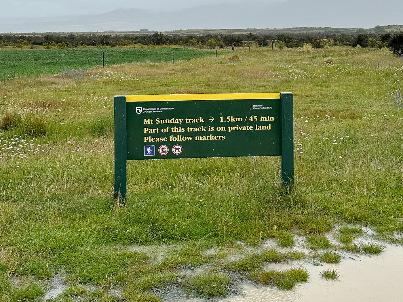 Department of Conservation sign for the Mount Sunday track, 1.5km from the car park in Hakatere Conservation Park, New Zealand