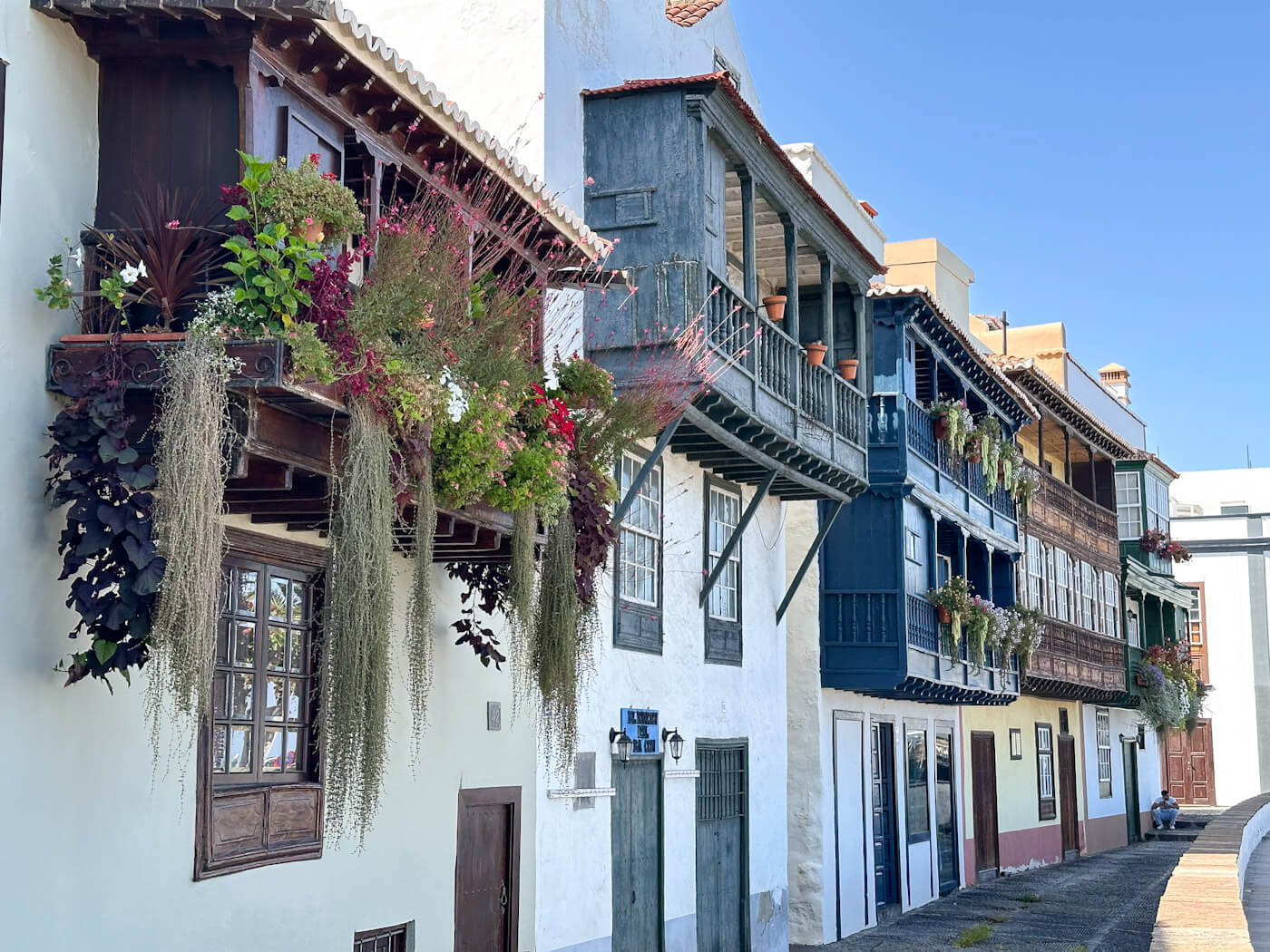 The historic, brightly coloured wooden balconies draped in flowers along Avenida Marítima in Santa Cruz de La Palma, showcasing traditional architecture as one of the best things to do in La Palma.