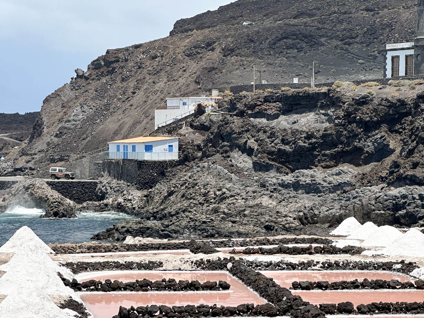 Bright white salt pyramids and pink evaporation pans at Salinas de Teneguía near the Fuencaliente lighthouse, featuring unique coastal landscapes for things to do in La Palma.