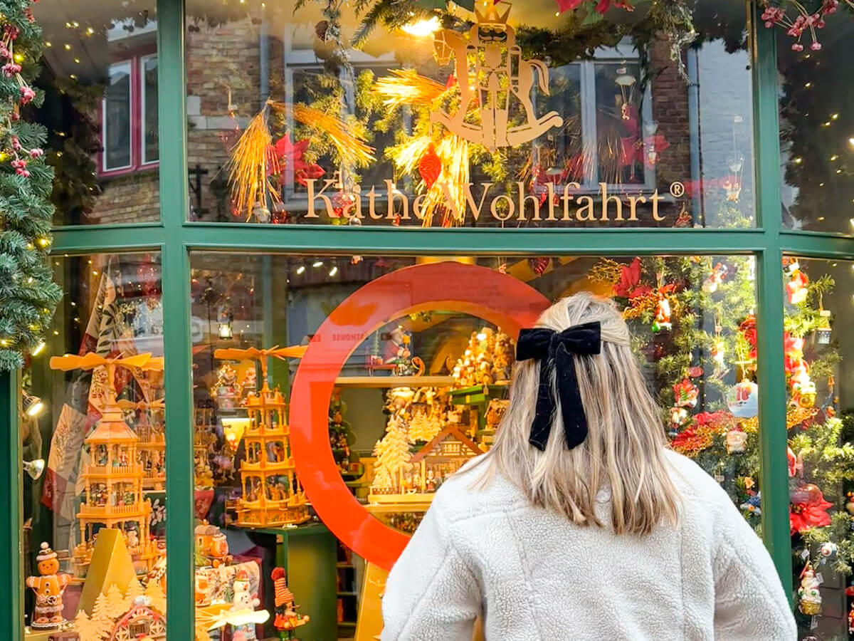 Charlie looking into the festive window display at the Käthe Wohlfahrt Christmas shop during Bruges at Christmas