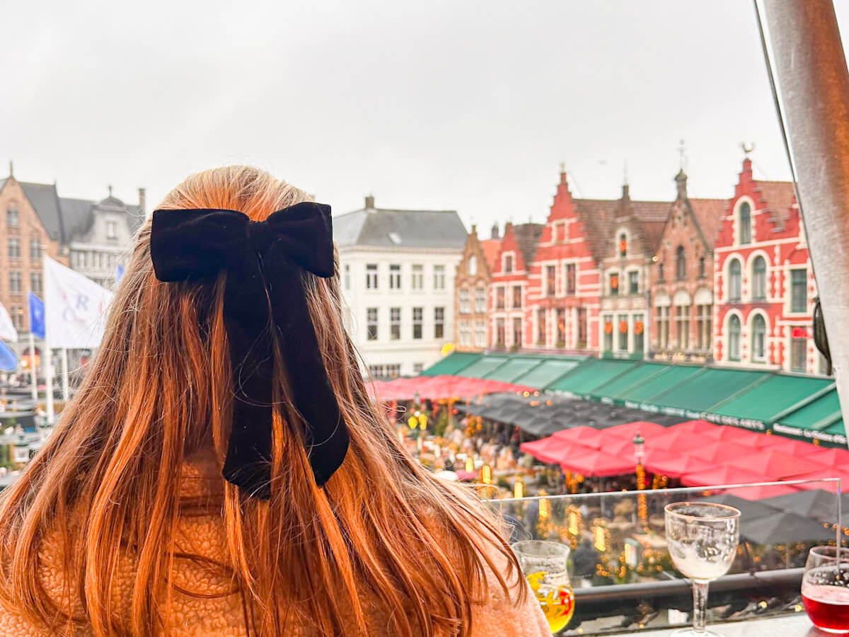 Charlie looking out over the Markt Christmas market from Duvelorium Belgian Beer Bar during Bruges at Christmas