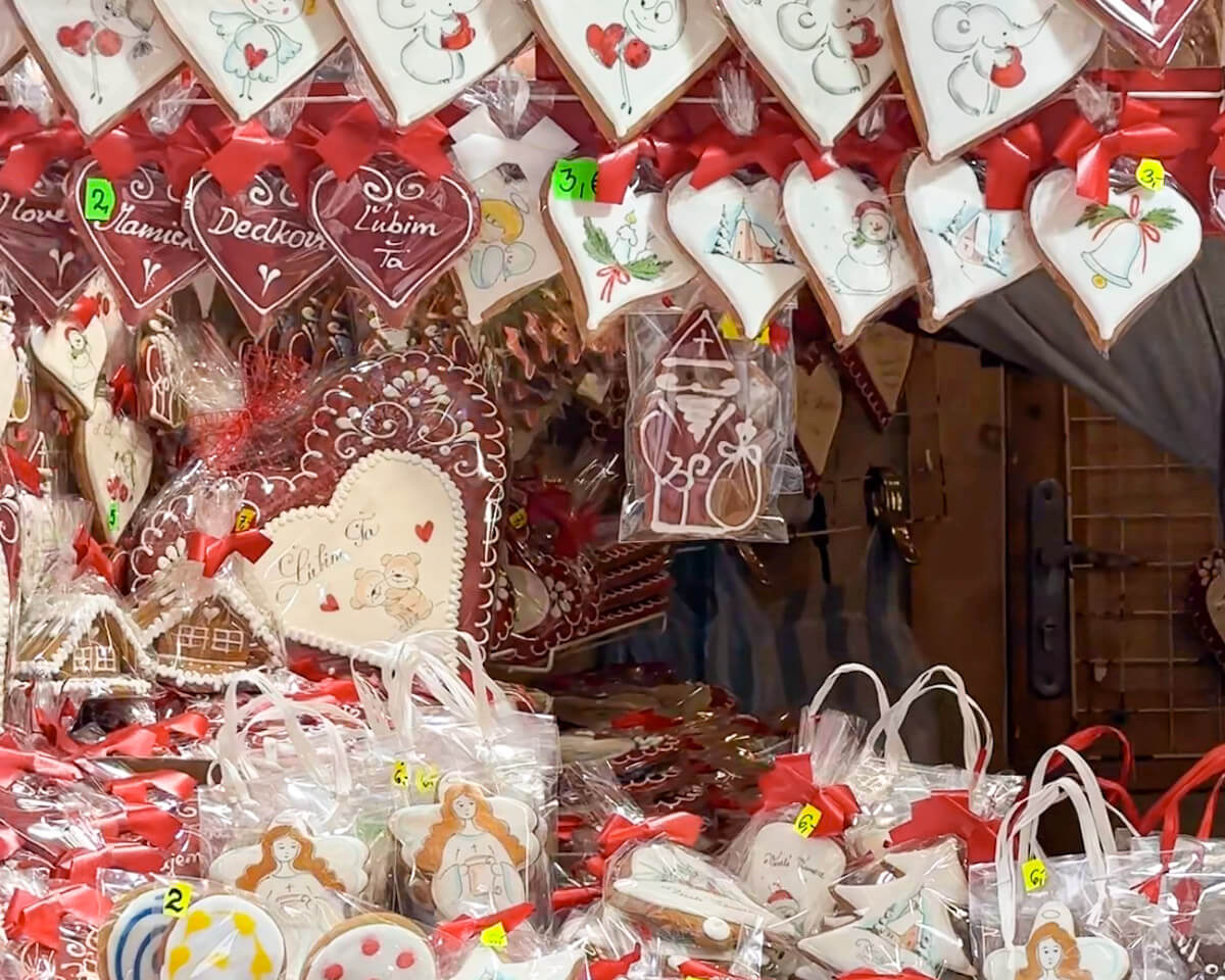 Intricately decorated traditional Slovak gingerbread cookies (medovnรญky) displayed for sale in plastic wrapping at a market stall during the Bratislava Christmas Market.